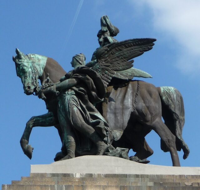 Eigentlich sollte die Frau (Genie) den Gaul führen, aber nach Einspruch des Kaisers trägt sie lediglich die Krone. panor